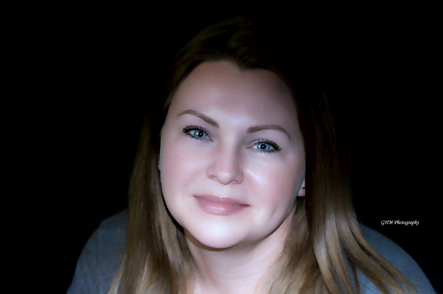 Close portrait of a woman against a dark background
